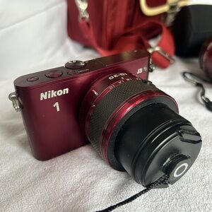 Nikon J3 maroon camera with additional lens